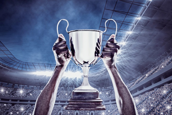 Composite image of cheering rugby player with cup